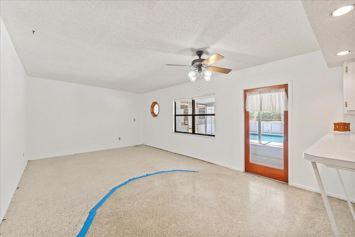 2862 Starlight Circle Northeast Palm Bay, FL 32905 - Photo 6 of 45 an empty room with windows and fan