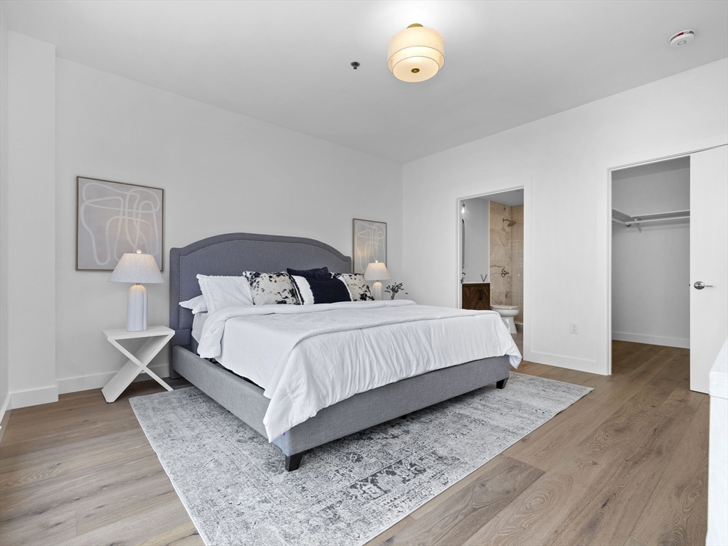 234 Causeway Street, Unit 906 Boston, MA 02114 - Photo 12 of 20 a bedroom with a bed and wooden floor
