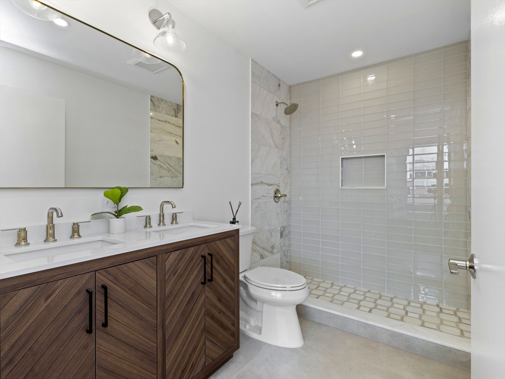 234 Causeway Street, Unit 906 Boston, MA 02114 - Photo 14 of 20 a bathroom with a sink a toilet and shower