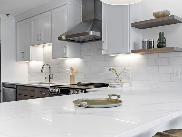 a kitchen with a sink a stove and cabinets