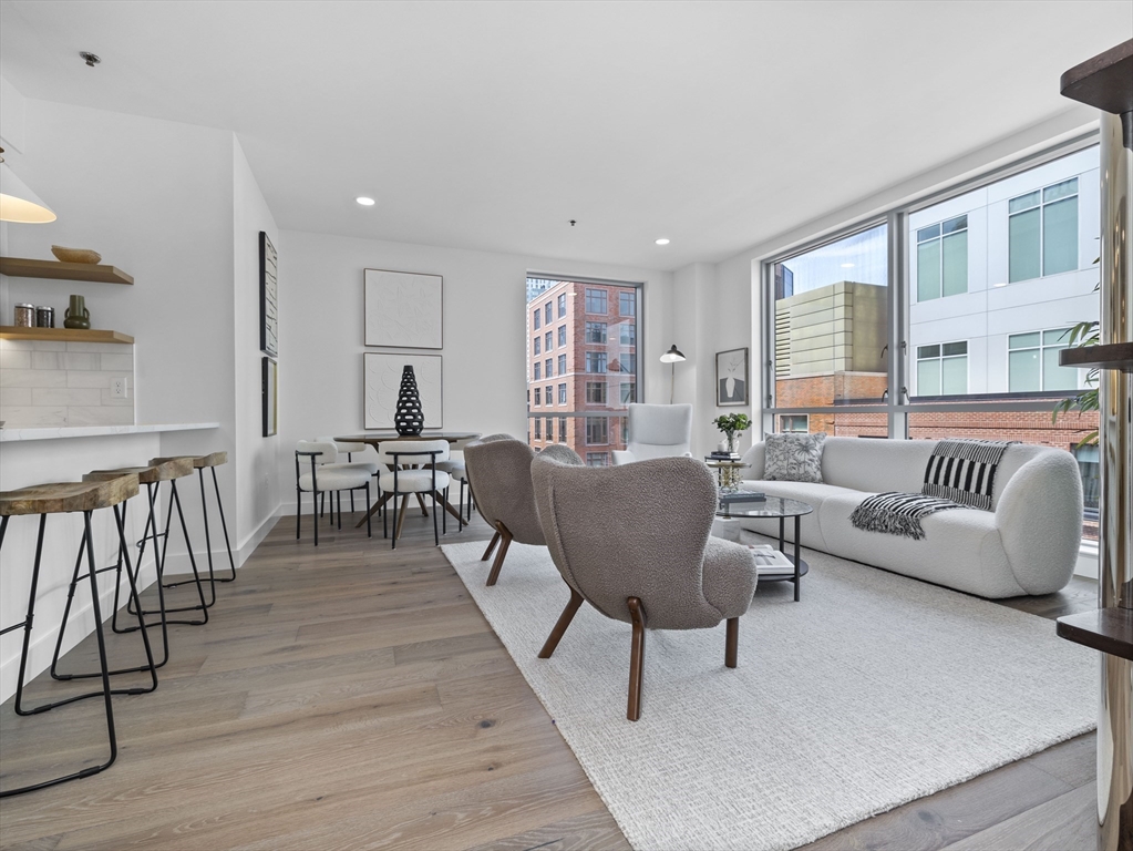 234 Causeway Street, Unit 906 Boston, MA 02114 - Photo 5 of 20 a living room with furniture wooden floor and a window