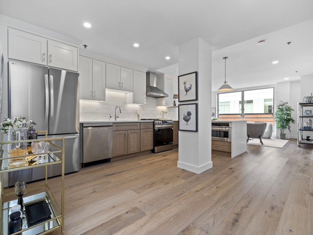 234 Causeway Street, Unit 906 Boston, MA 02114 - Photo 10 of 20 a kitchen with stainless steel appliances a refrigerator sink and cabinets