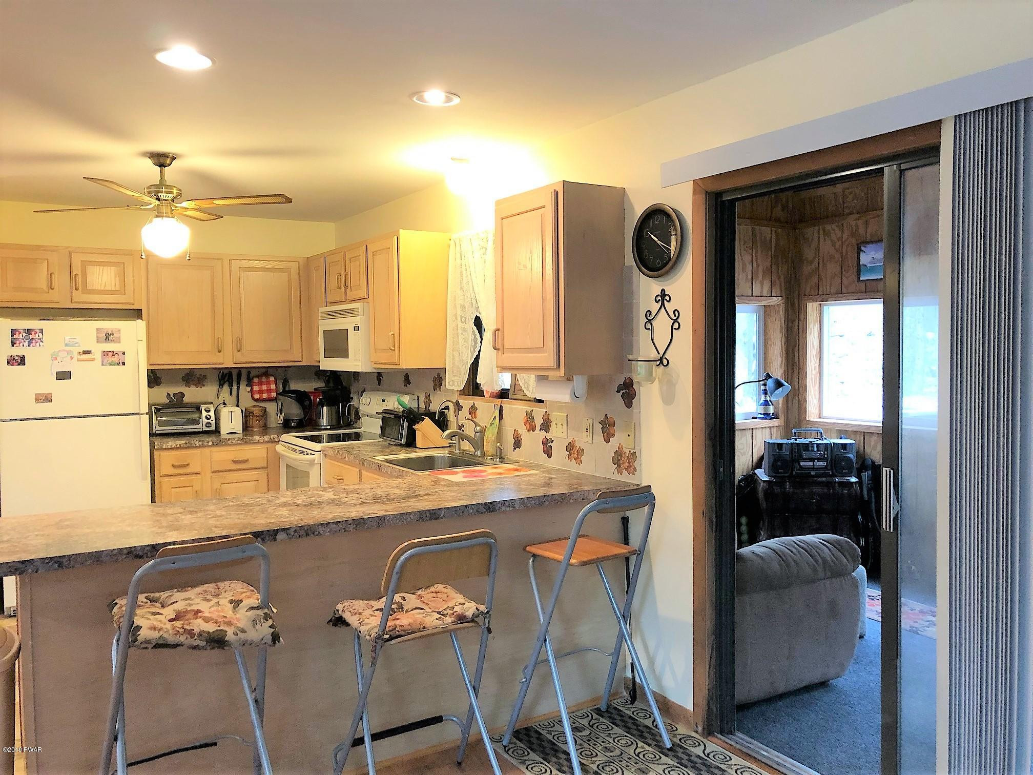 3039 Northgate Road Lake Ariel, PA 18436 - Photo 7 of 57 a view of a kitchen and living room