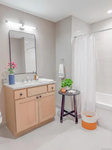 a bathroom with a sink vanity and a mirror
