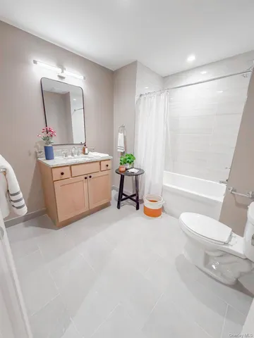 a bathroom with a granite countertop sink mirror vanity and bathtub