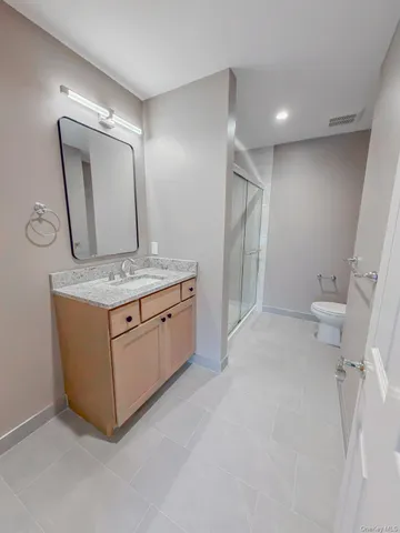 a bathroom with a sink a toilet and mirror