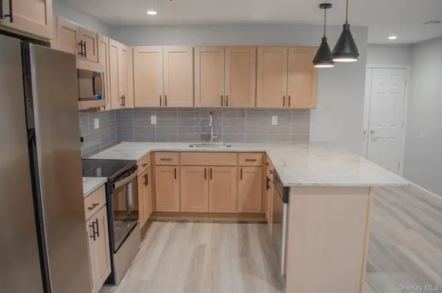 a kitchen with a sink a stove a refrigerator and cabinets