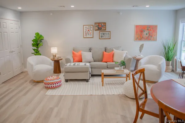 a living room with furniture and a potted plant