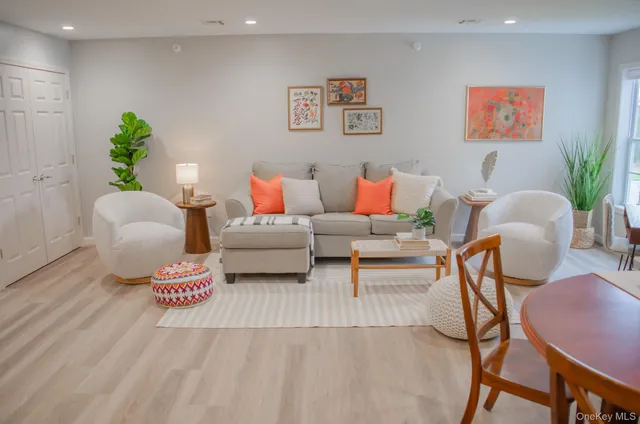 a living room with furniture and a potted plant