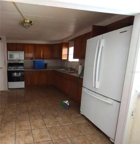 a kitchen with stainless steel appliances a refrigerator and a stove top oven