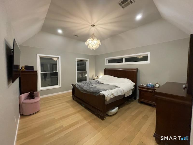 95 Old Breakneck Road Killingly, CT 06241 - Photo 20 of 39 a bedroom with a bed and wooden floor