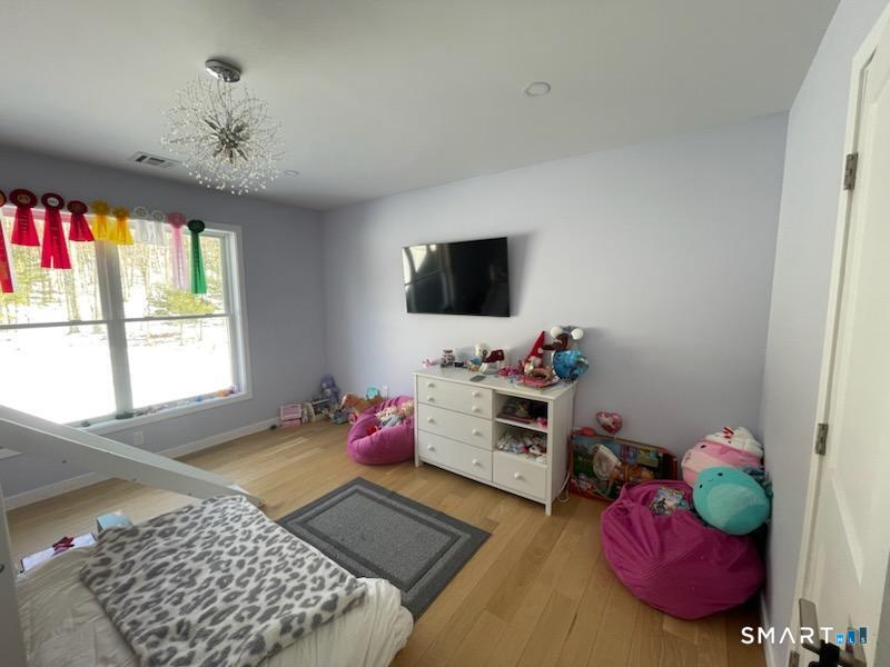 95 Old Breakneck Road Killingly, CT 06241 - Photo 24 of 39 a bedroom with furniture and a flat screen tv