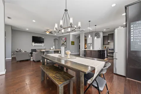 a large kitchen with a table and chairs