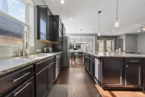 a kitchen with stainless steel appliances granite countertop lots of counter space and a sink