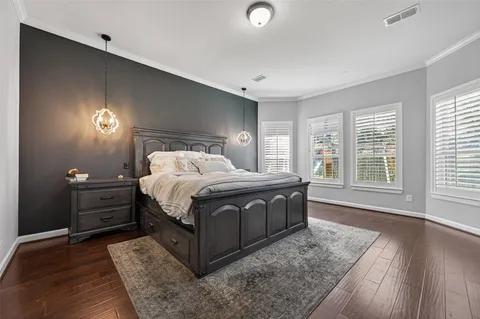 a bed sitting in a spacious bedroom next to a window