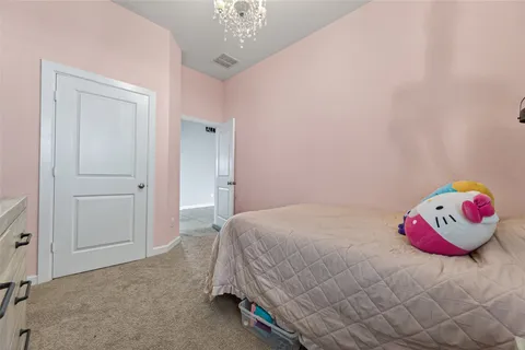 a bedroom with a bed and a chandelier