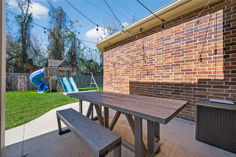 a view of a patio with a table and chairs