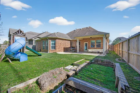 a view of a house with backyard and a sitting area
