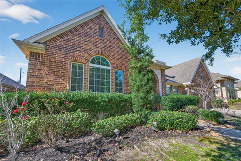 a front view of a house with plants