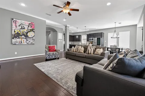 a living room with furniture and kitchen view