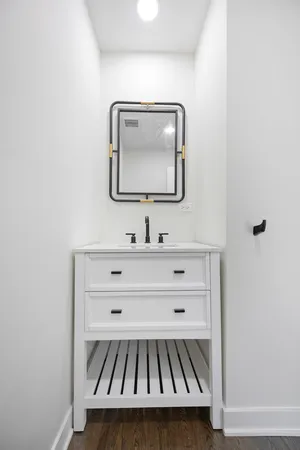 a bathroom with a sink vanity and mirror