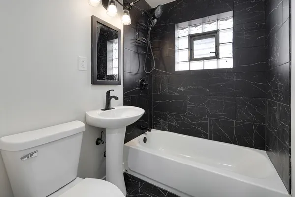 a bathroom with a sink a toilet and bathtub