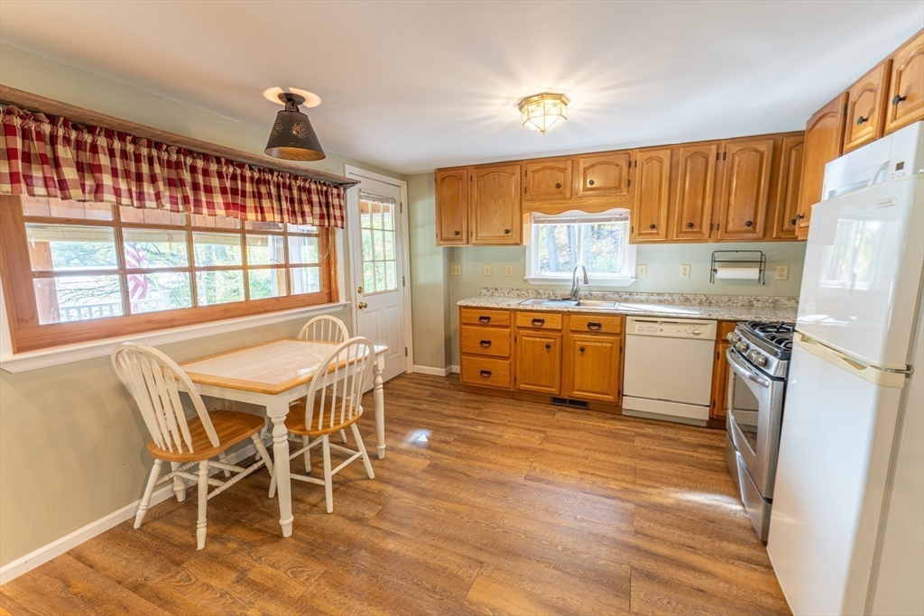 9 Chandler Road Holland, MA 01521 - Photo 12 of 42 a kitchen with stainless steel appliances a stove a sink refrigerator and cabinets