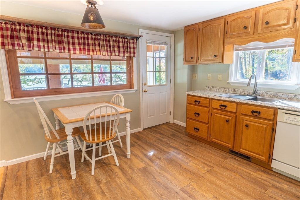 9 Chandler Road Holland, MA 01521 - Photo 13 of 42 a open kitchen with granite countertop a stove a sink and a dining table with granite countertops