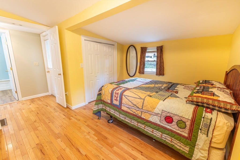 9 Chandler Road Holland, MA 01521 - Photo 18 of 42 a bedroom with a bed and dresser with wooden floor