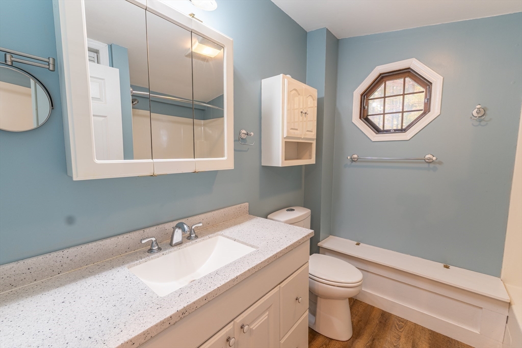 9 Chandler Road Holland, MA 01521 - Photo 21 of 42 a bathroom with a granite countertop toilet a sink and mirror