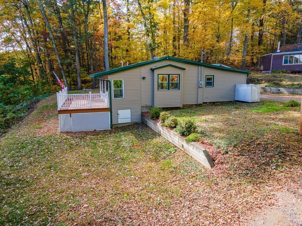9 Chandler Road Holland, MA 01521 - Photo 3 of 42 a backyard of a house with wooden fence and large trees