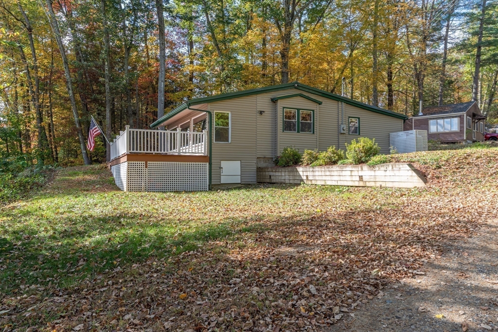 9 Chandler Road Holland, MA 01521 - Photo 6 of 42 a front view of house with yard and trees in the background