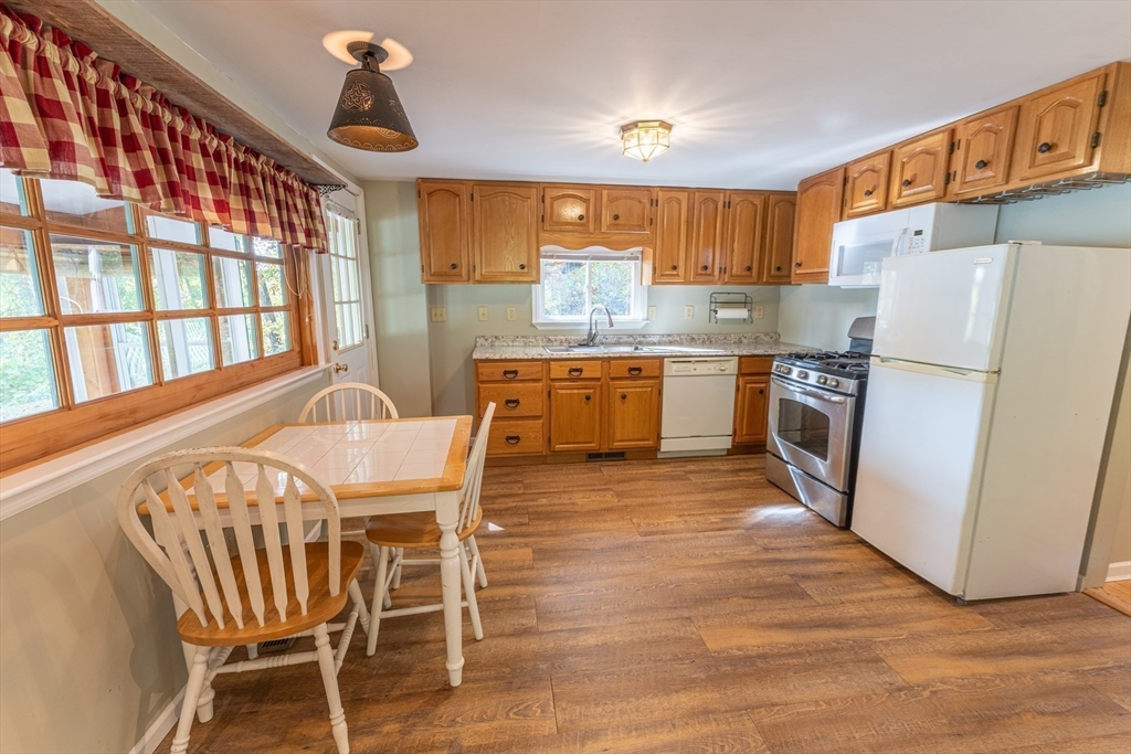 9 Chandler Road Holland, MA 01521 - Photo 10 of 42 a kitchen with a table chairs refrigerator and microwave