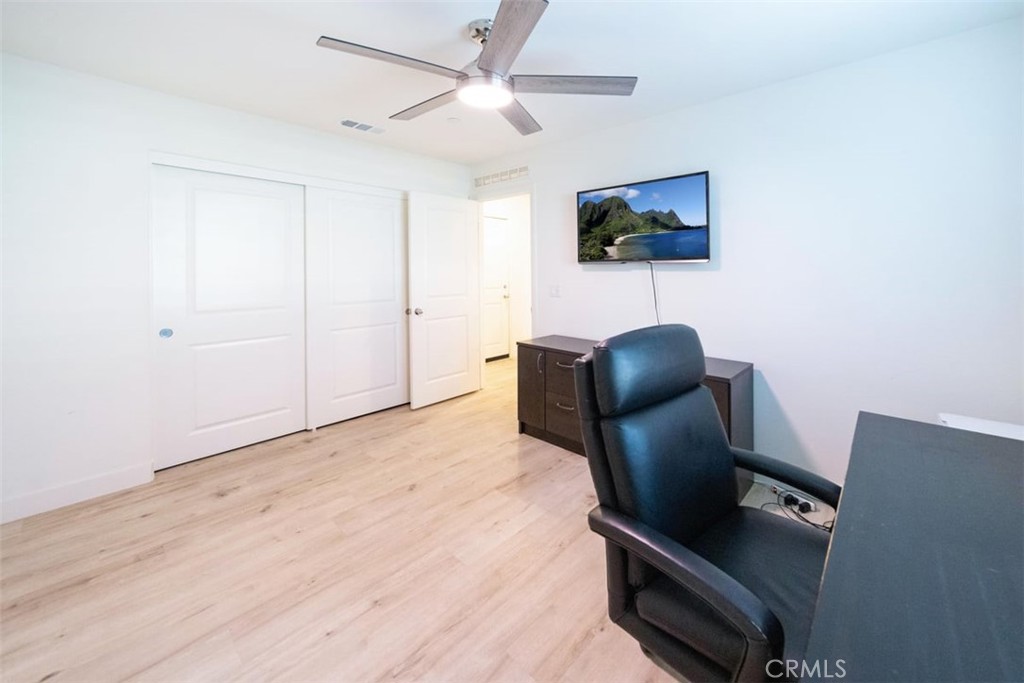 32078 Rambling Court Winchester, CA 92596 - Photo 21 of 48 a workspace with furniture and a flat screen tv