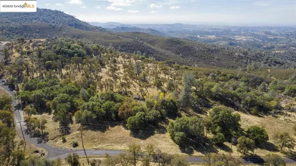a view of a yard with mountains in the background