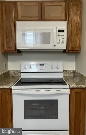 a stove top oven sitting inside of a kitchen