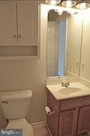 a bathroom with a sink toilet and vanity