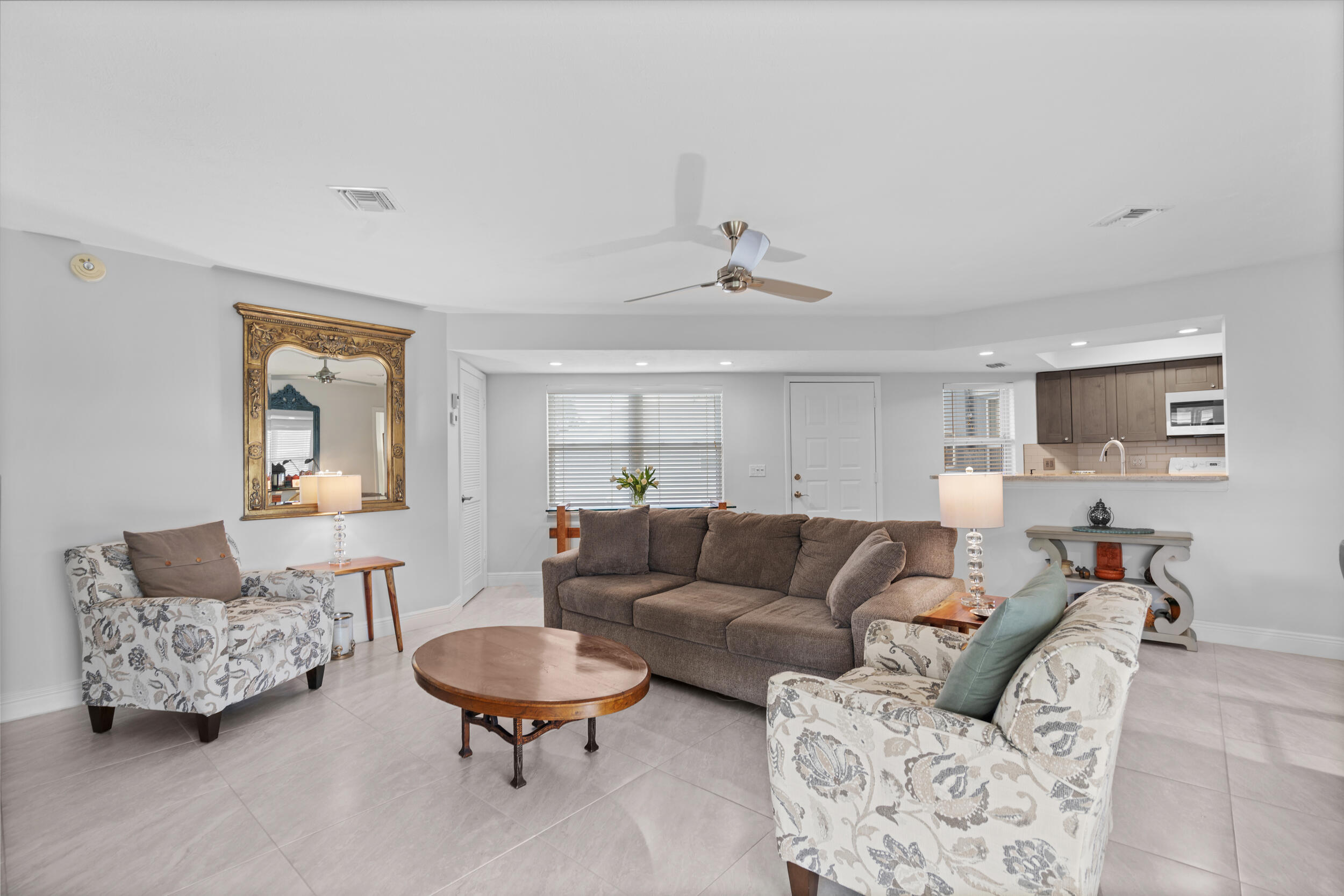 3236 Southeast Aster Lane, Unit M228 Stuart, FL 34994 - Photo 1 of 51 a living room with furniture and a blue couch