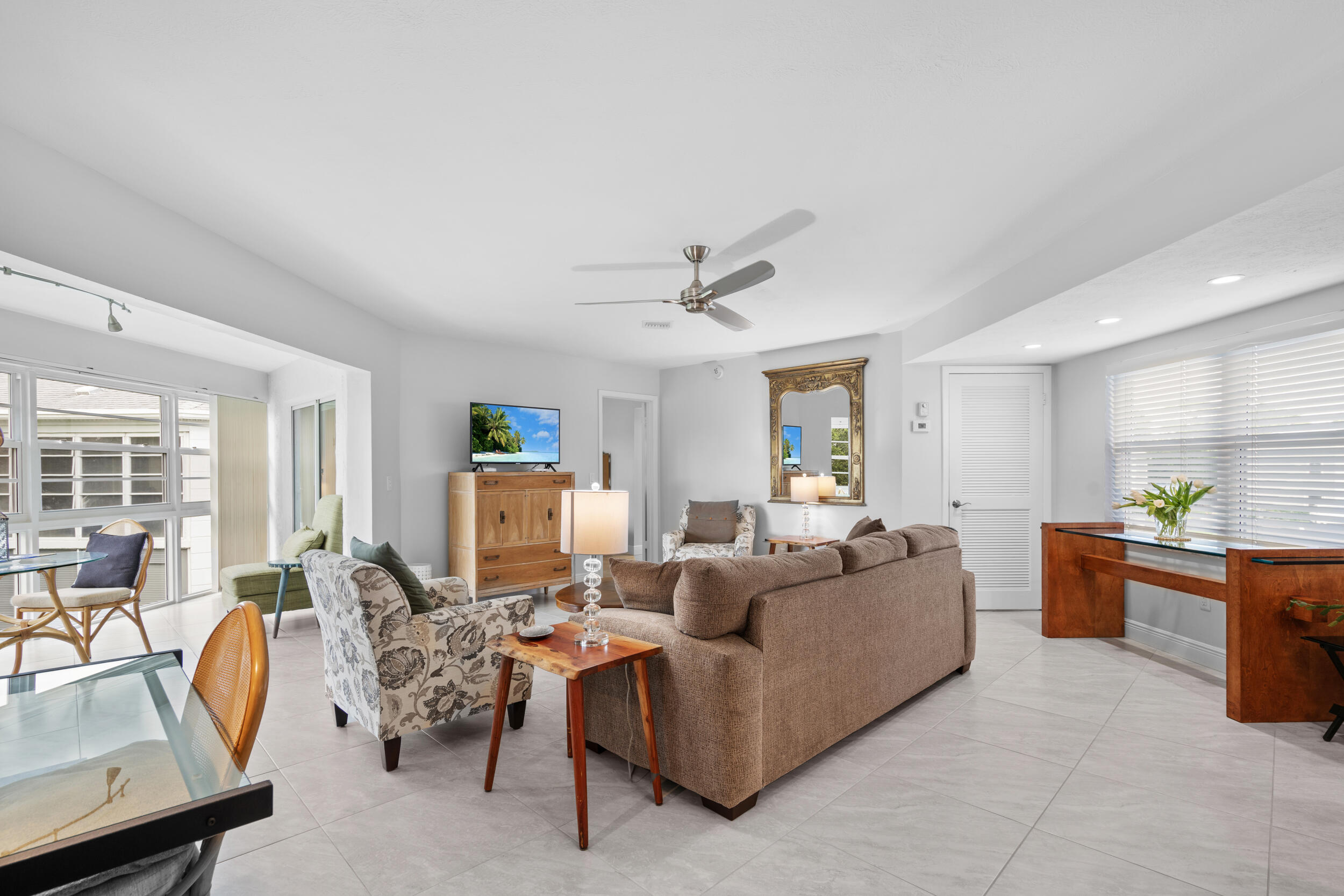 3236 Southeast Aster Lane, Unit M228 Stuart, FL 34994 - Photo 12 of 51 a living room with furniture a window and a table