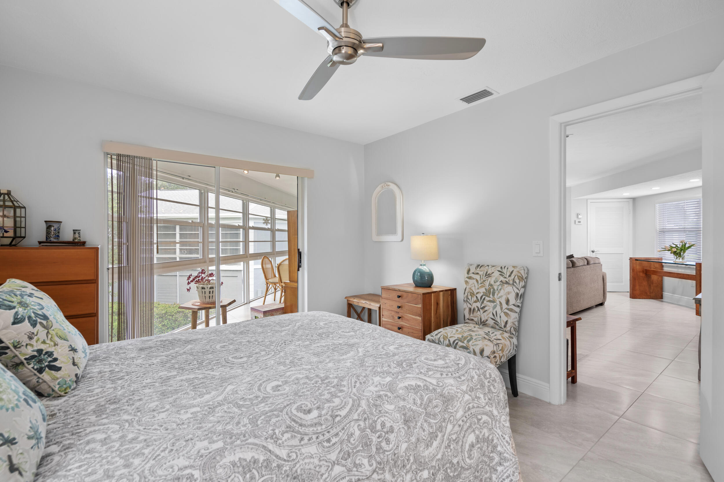 3236 Southeast Aster Lane, Unit M228 Stuart, FL 34994 - Photo 17 of 51 a bedroom with a large bed and a large window