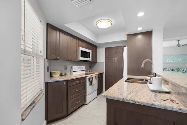 a kitchen with a sink stove and microwave