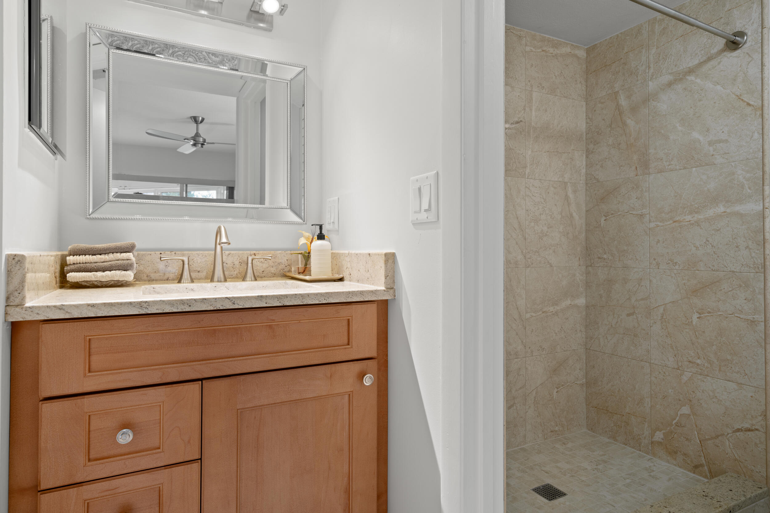 3236 Southeast Aster Lane, Unit M228 Stuart, FL 34994 - Photo 22 of 51 a bathroom with a sink and a mirror