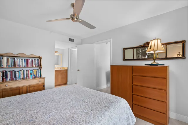 a bedroom with a bed and a book shelf