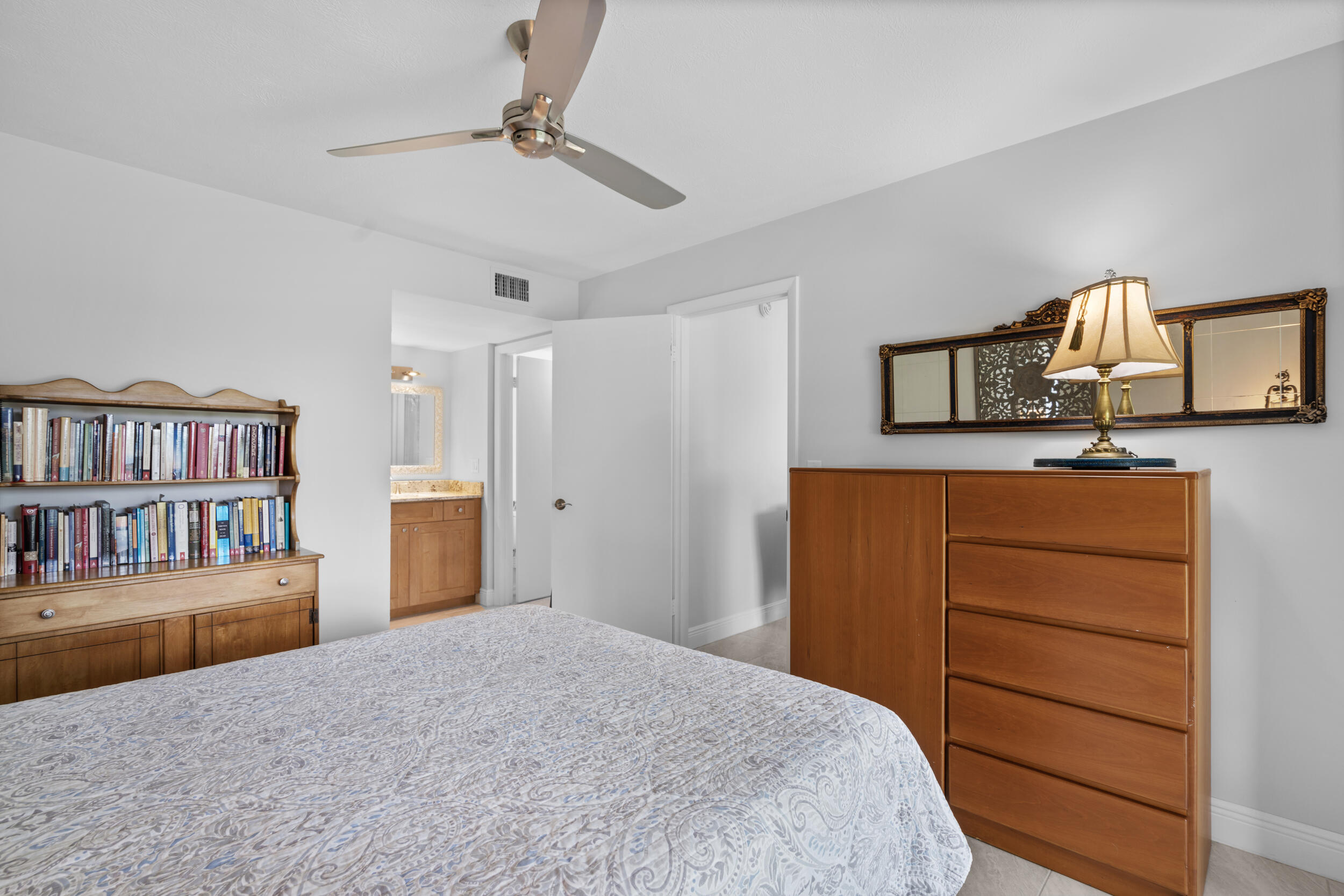 3236 Southeast Aster Lane, Unit M228 Stuart, FL 34994 - Photo 28 of 51 a bedroom with a bed and closet