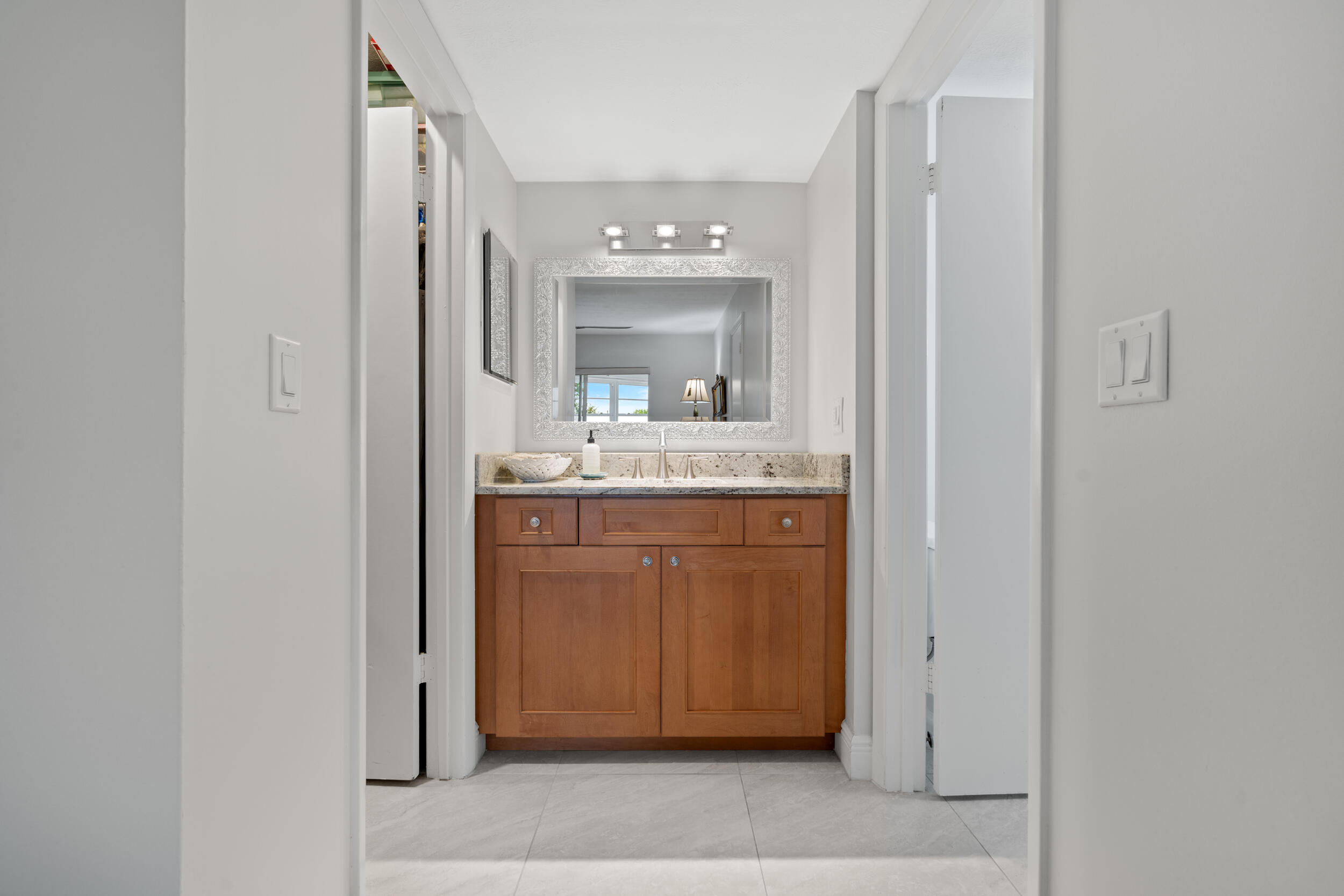 3236 Southeast Aster Lane, Unit M228 Stuart, FL 34994 - Photo 30 of 51 a bathroom with a sink and a mirror