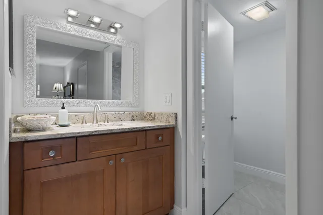 a bathroom with a double vanity sink and mirror with shower