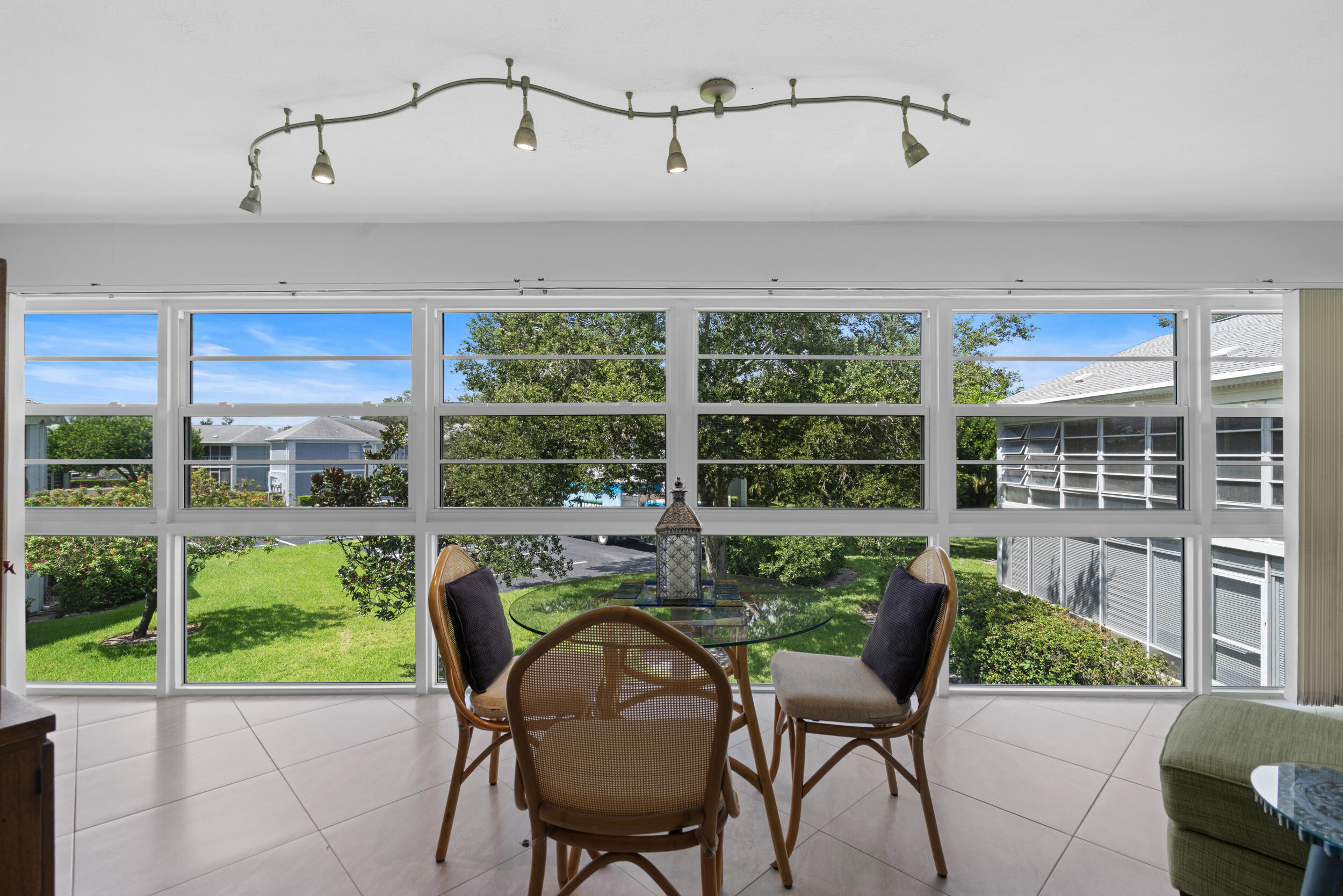 3236 Southeast Aster Lane, Unit M228 Stuart, FL 34994 - Photo 3 of 51 a view of a chairs and table in the room and balcony