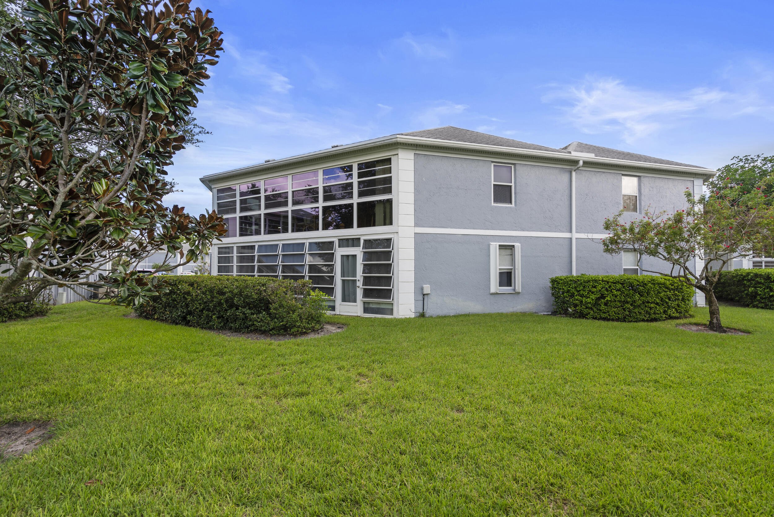 3236 Southeast Aster Lane, Unit M228 Stuart, FL 34994 - Photo 39 of 51 a view of a house with a backyard