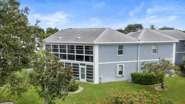 an aerial view of multiple houses with yard