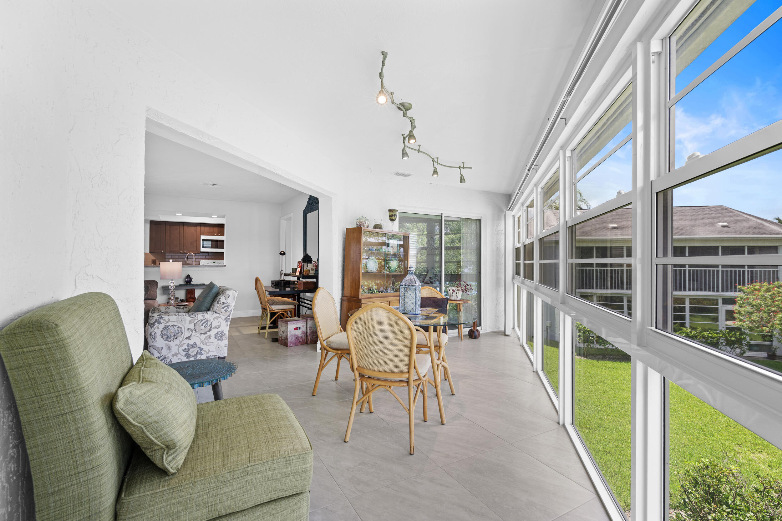 3236 Southeast Aster Lane, Unit M228 Stuart, FL 34994 - Photo 4 of 51 a living room with furniture and a large window